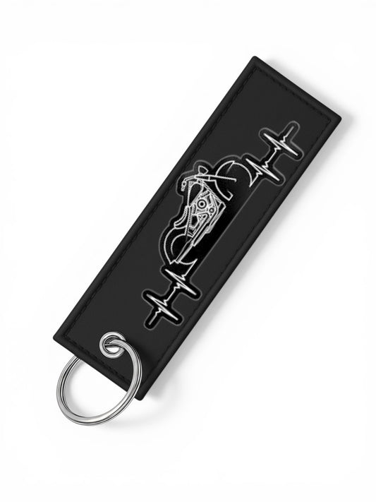 One Touch Hold black motorcycle heartbeat keychain fob with silver ring. Durable material with unique design.